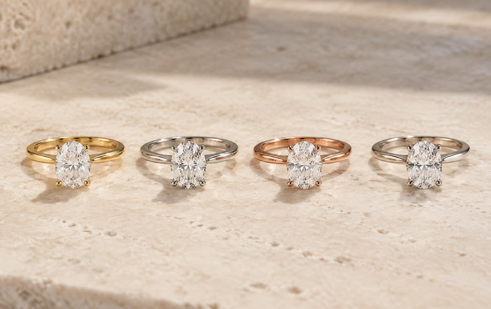 Four matching solitaire ring studies in yellow gold, white gold, rose gold, and platinum