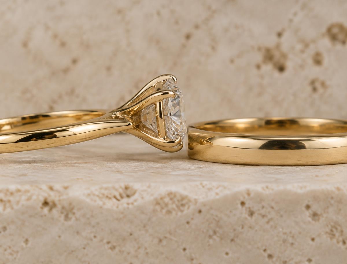 Side profile of an engagement ring whose basket blocks a straight wedding band, leaving a visible gap