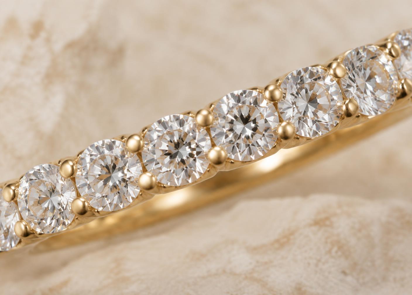 Neighboring round diamonds sharing polished gold prongs between stones